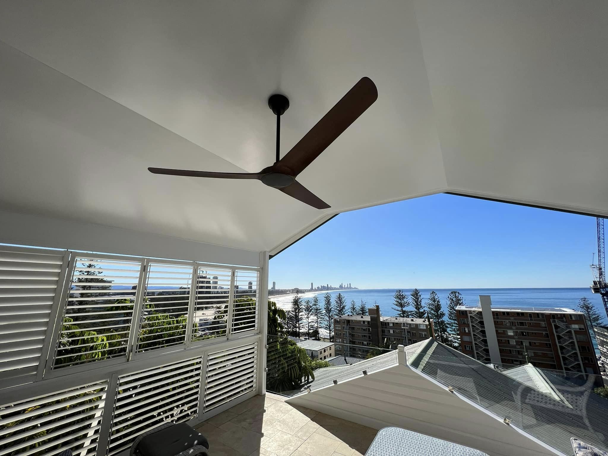 Ceiling fan on covered balcony overlooking Gold Coast ocean view.
